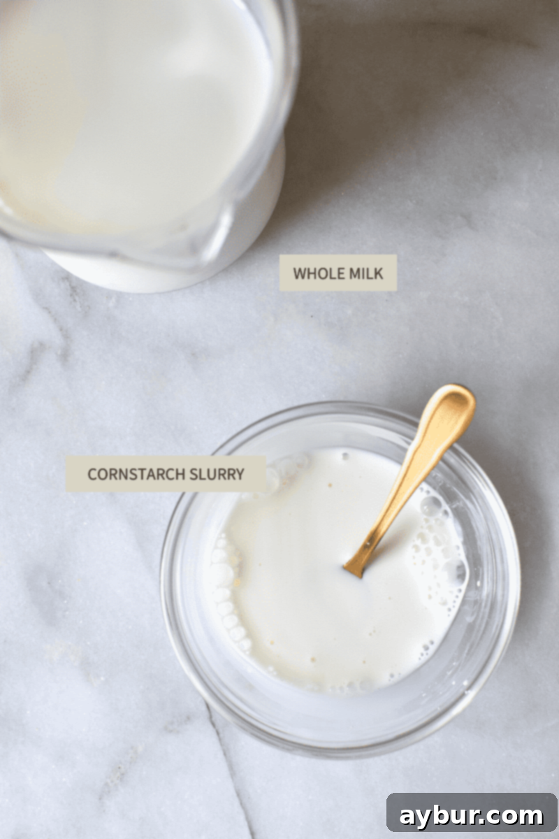 A small bowl containing a cornstarch slurry, a key ingredient for thickening the ice cream base.