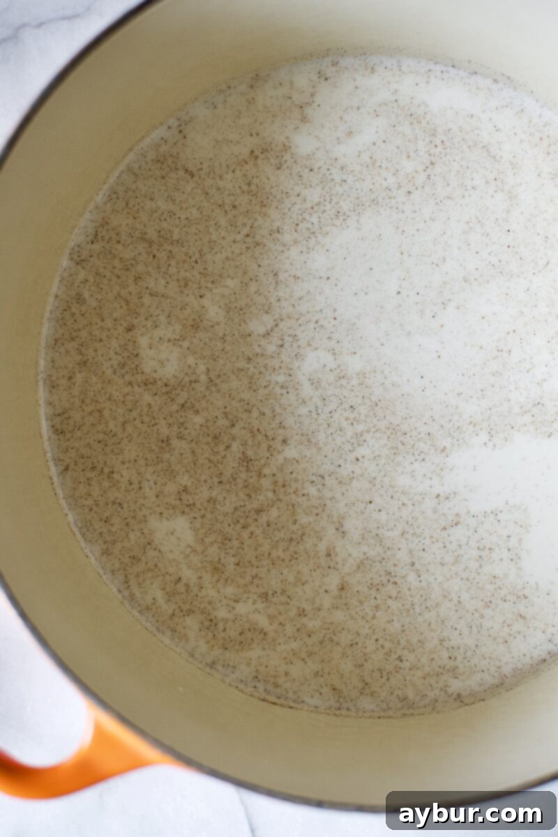 The ice cream base ingredients warming gently in a saucepan.