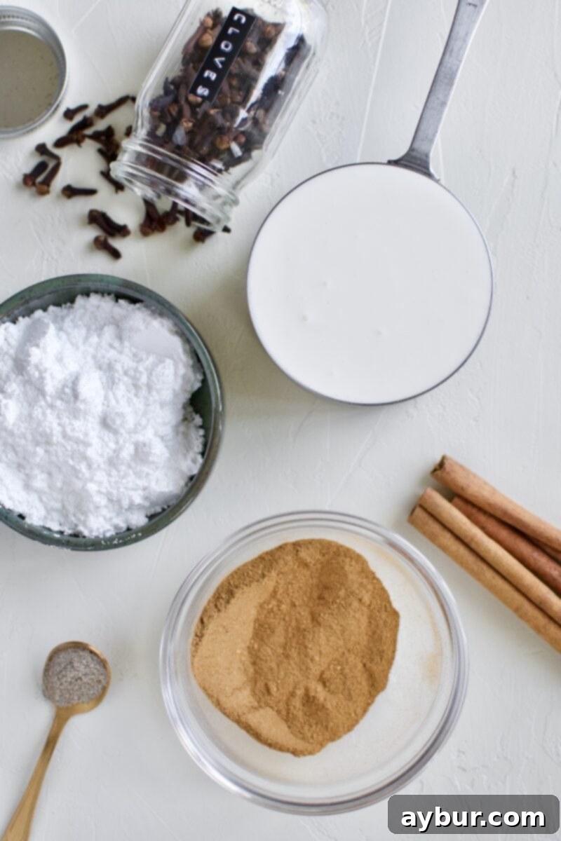 Close-up of the ingredients for Chai Spiced Whipped Cream: heavy cream, powdered sugar, and chai spice, ready to be whipped.