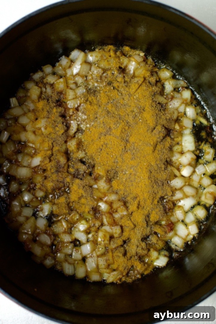 Butter chicken spices added to the cooked onions.