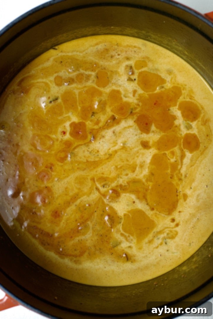 Tomato paste and coconut milk added to the pot.