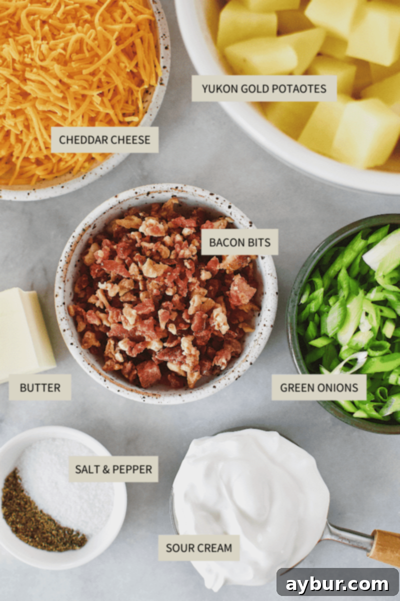 Loaded Baked Potato Mash 3 A collection of ingredients laid out, including potatoes, butter, cheese, sour cream, green onions, and bacon, ready for making Loaded Baked Potato Mashers.