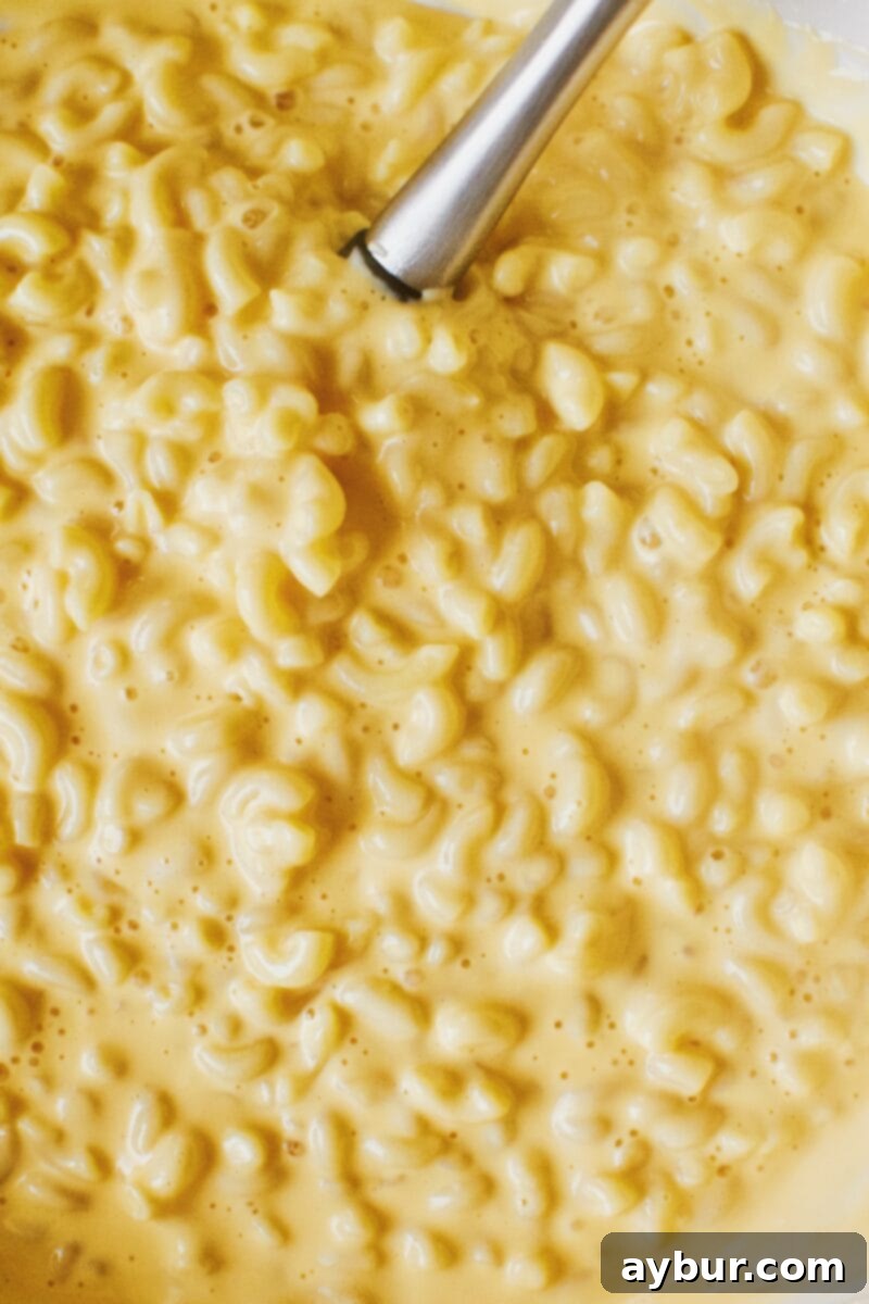 Ultimate Cheez-It Mac and Cheese 6 Cooked macaroni and cheddar syrup mixed together in a bowl.