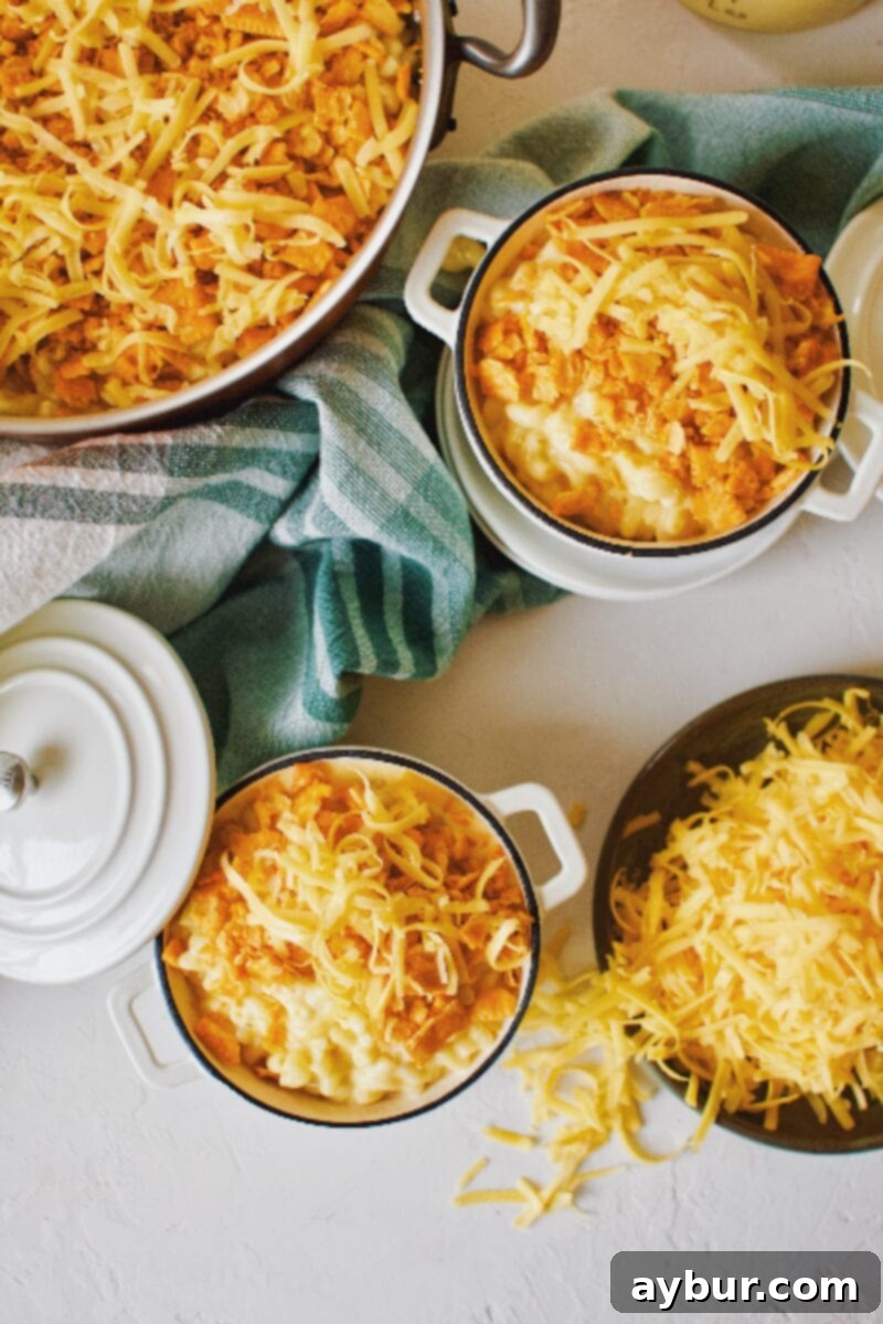 Ultimate Cheez-It Mac and Cheese 9 Cheez-It mac and cheese in mini dutch ovens topped with cheese crackers and cheddar cheese.