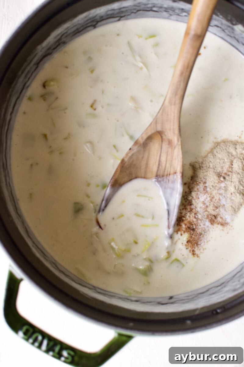 Cheesy Cauliflower and Leek Gratin 7 Heavy cream, salt, white pepper, and nutmeg being added to the creamy sauce base.