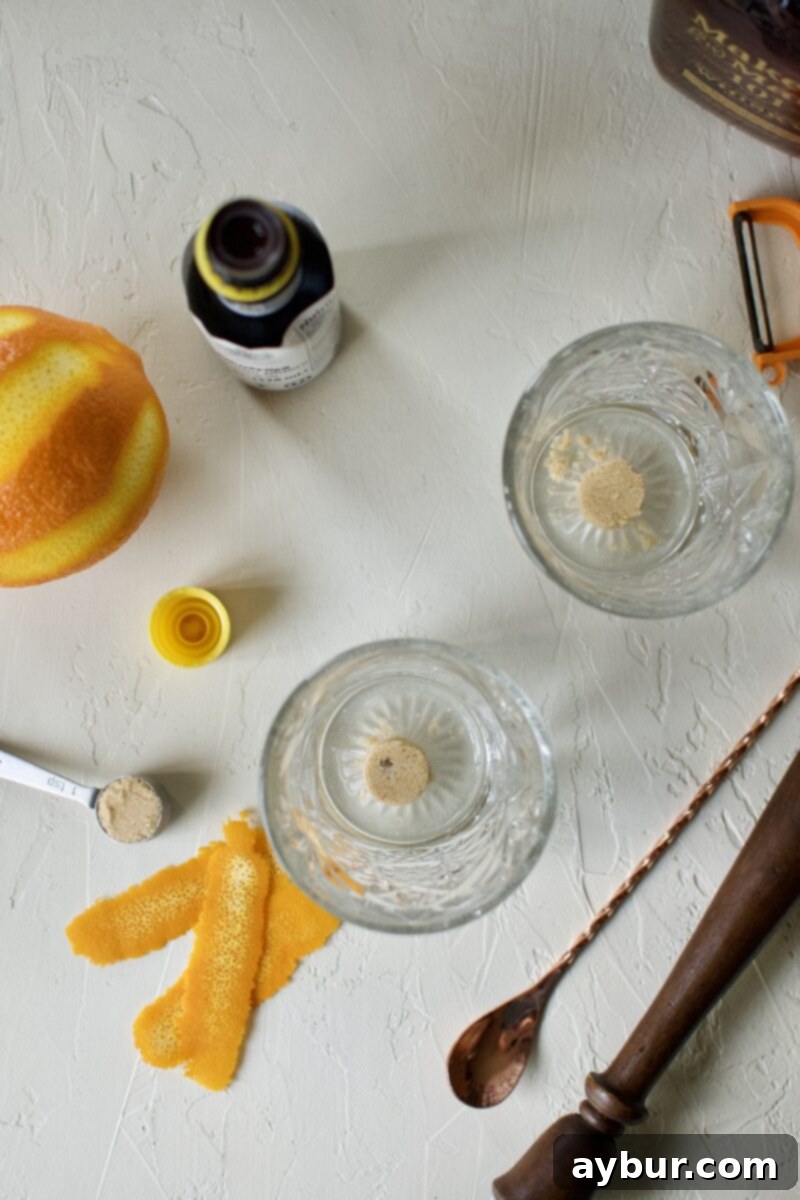 Close-up of brown sugar placed at the bottom of a cocktail glass, ready for muddling.