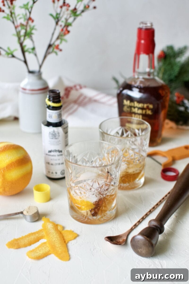 A close-up shot of a perfectly stirred Bourbon Brown Sugar Old Fashioned, showcasing its rich color and garnishes.