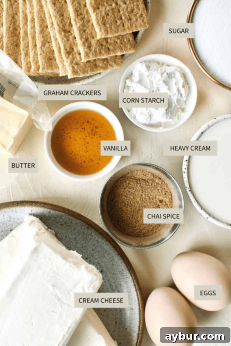A flat lay photograph showing all the necessary ingredients for Chai-Spiced Cheesecake laid out on a surface.
