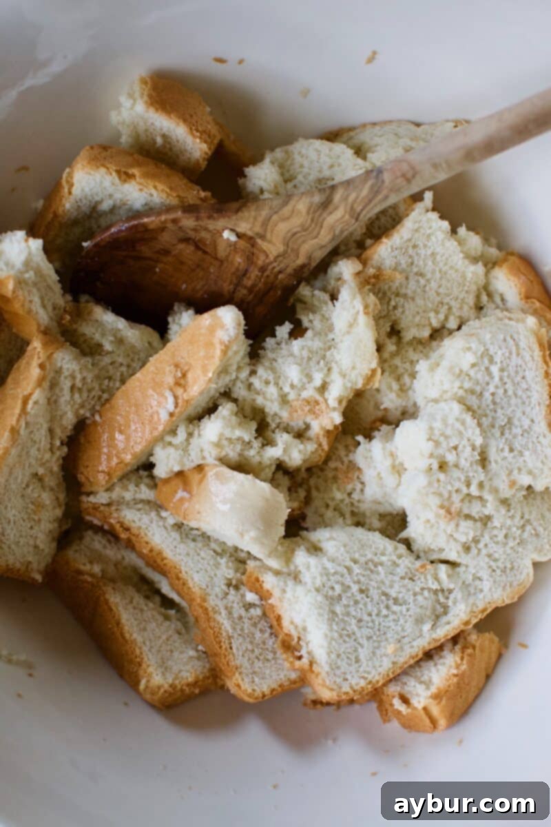 Mega Meatball Masterpiece 4 Texas Toast slices generously soaking in Whole Milk in a mixing bowl.