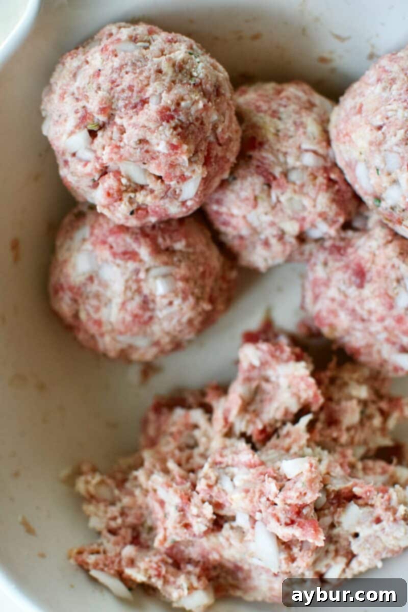 Mega Meatball Masterpiece 9 A hand portioning out the giant meatball mixture using a kitchen scale for accuracy.