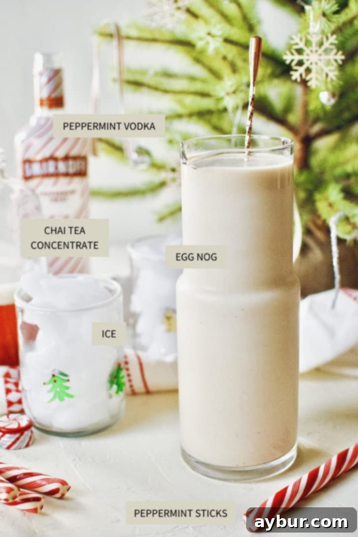 Key ingredients for the Peppermint Chai Eggnog Cocktail, including eggnog, chai concentrate, and peppermint vodka, artfully arranged on a rustic table.