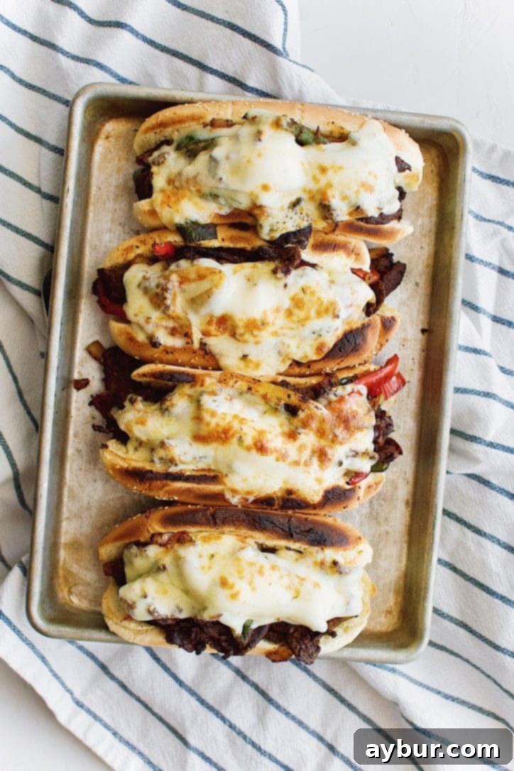 A close-up of Joanna Gaines's take on Philly Cheesesteaks from the Magnolia Table Cookbook Vol. 2, highlighting the thinly sliced steak and colorful vegetables.