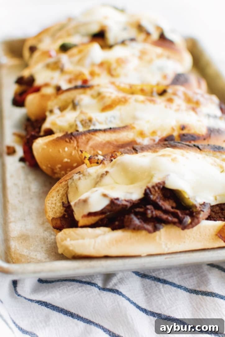 The finished Joanna Gaines Philly Cheesesteak, served on a roll with melted cheese and fresh herbs, from the Magnolia Table Cookbook Vol. 2.
