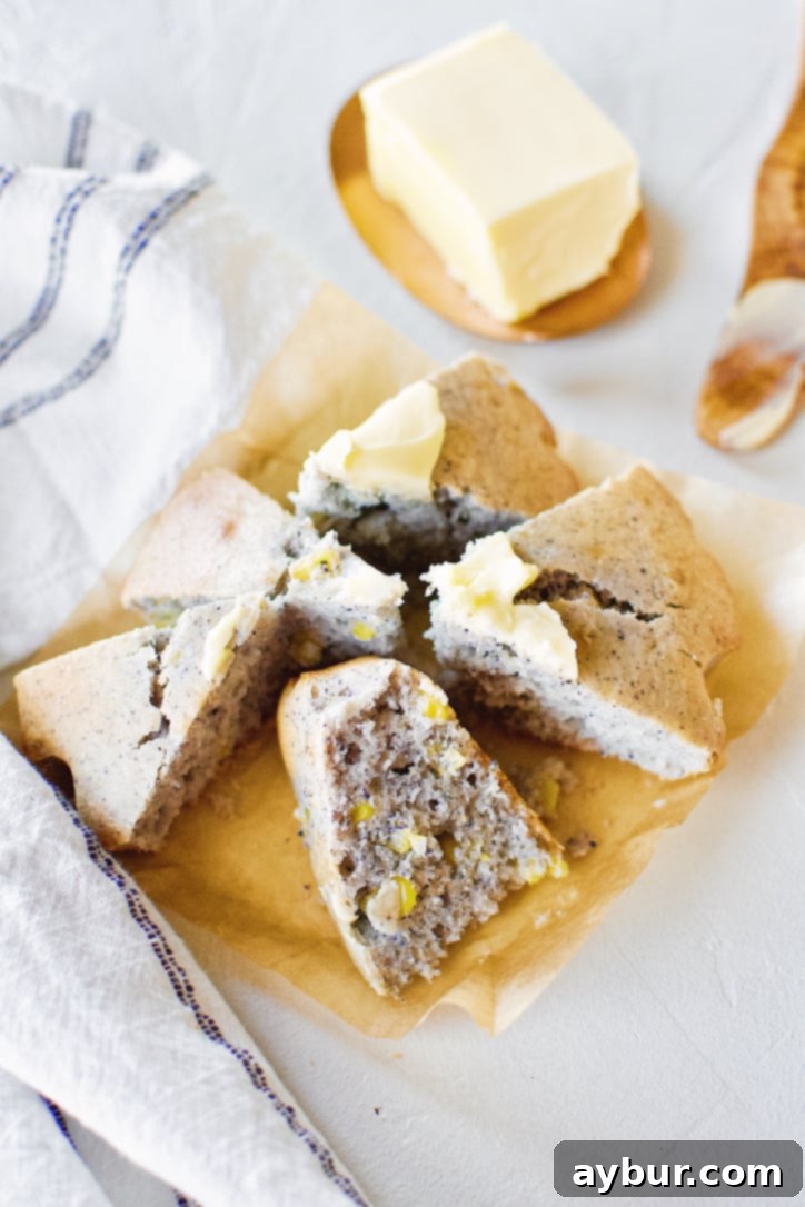 Freshly baked blue cornbread slices topped with melting butter, showcasing its unique color and tender texture.