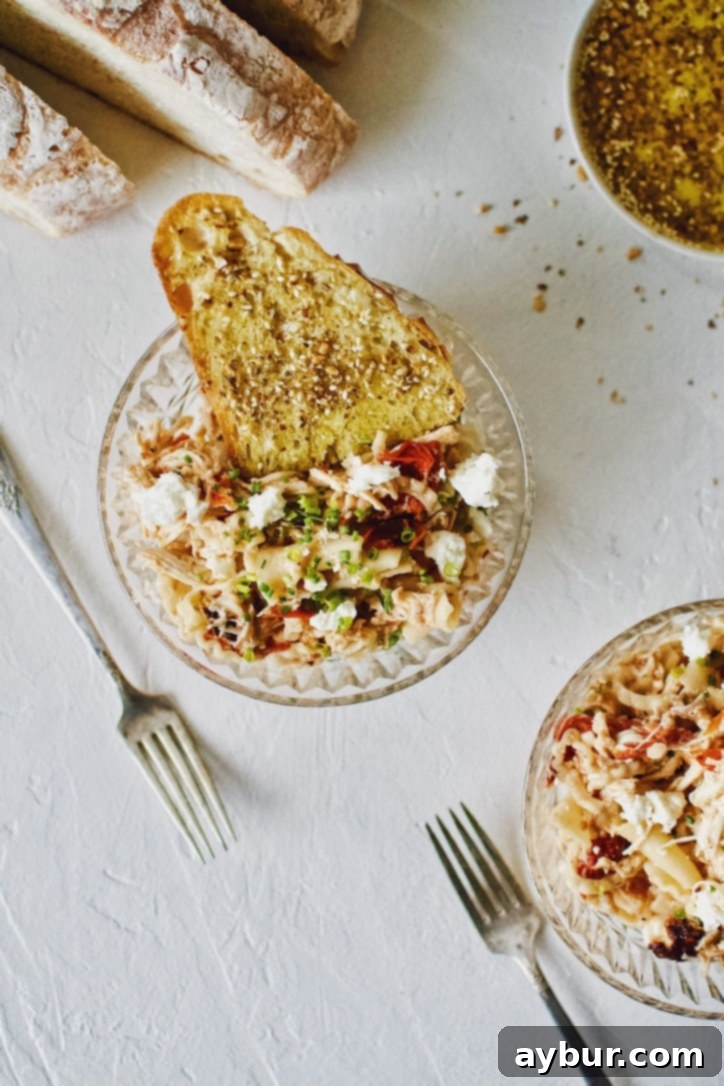 Easy Baked Feta Pasta with Chicken 2 Baked Feta Pasta with Chicken served in bowls with crust bread dipped in olive oil.