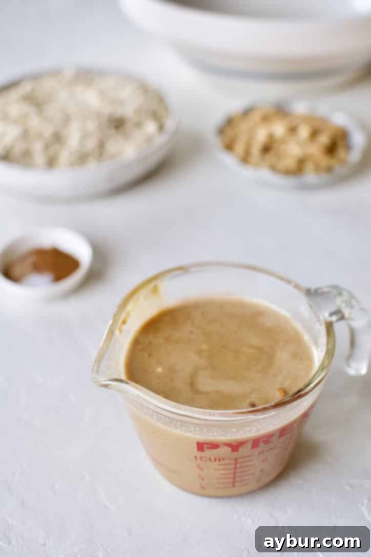 Ultimate Peanut Butter Granola Crunch 5 Melted wet ingredients mixed together for Crunchy Peanut Butter Granola