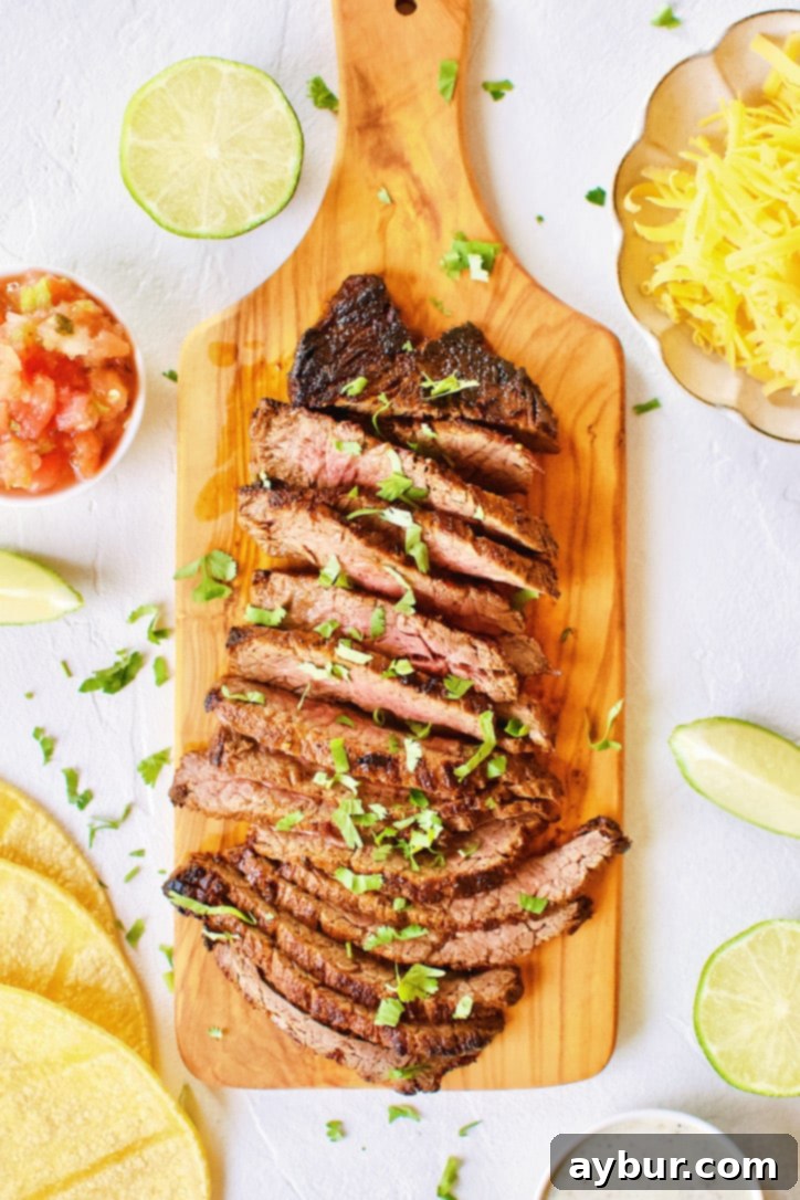 Carne Asada Fajita Steak on a chopping board, perfectly seared and ready to be sliced.