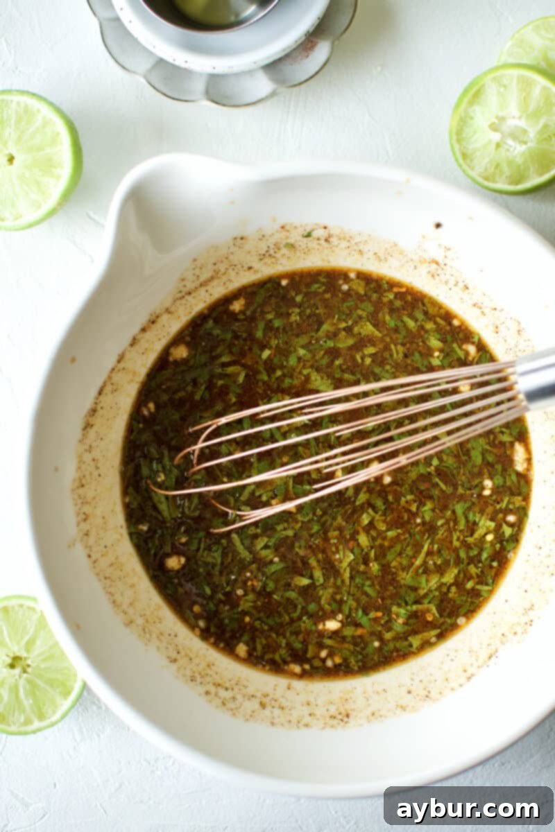 Close-up of the prepared Carne Asada Fajita Marinade in a glass bowl, ready for the steak.