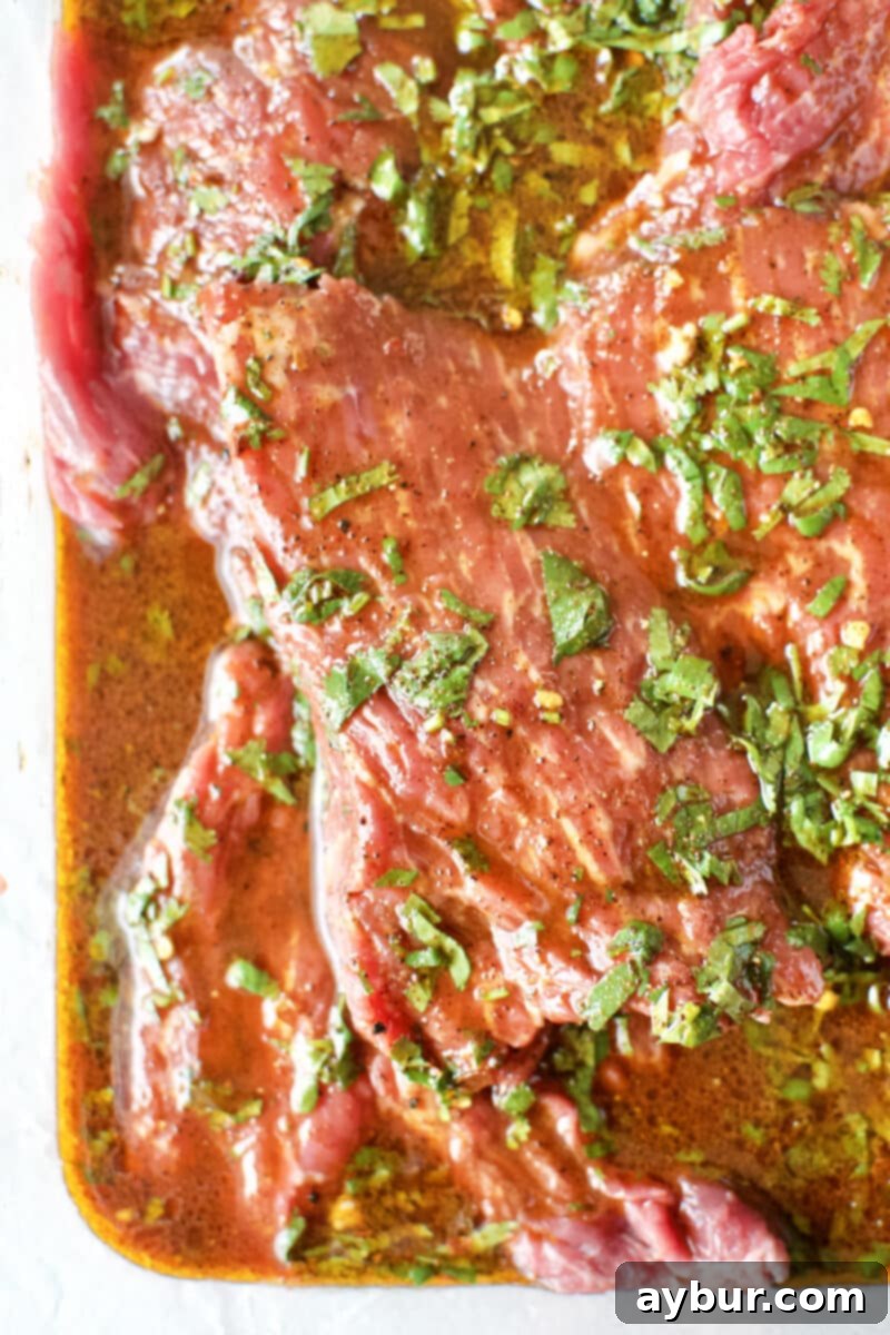 Beef Loin Flap Meat Steak fully marinating in a shallow pan, soaking up the flavors.