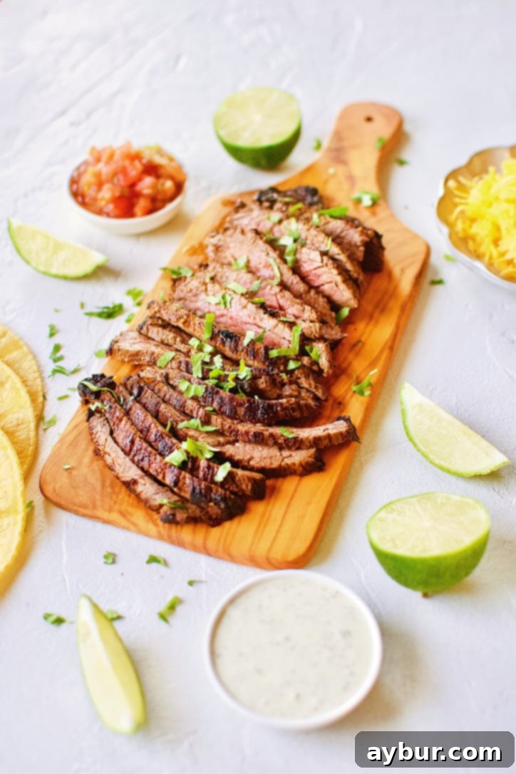 Sliced Carne Asada Fajita Steak on a wooden chopping board, showcasing its tender texture and perfect sear.