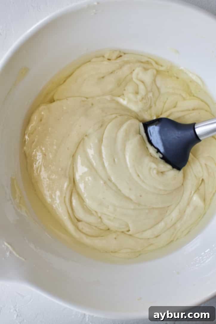 Folding in the oil to the cake batter.