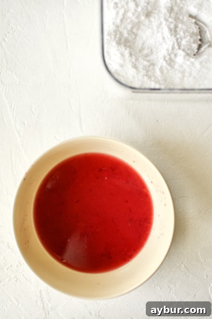 Blood Orange Juice in a bowl and powdered sugar in a canister.