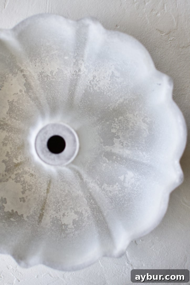 A buttered and floured bundt cake pan.