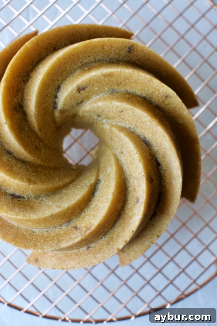 The cake cooling outside of the pan on a wire rack, developing a subtle crust.