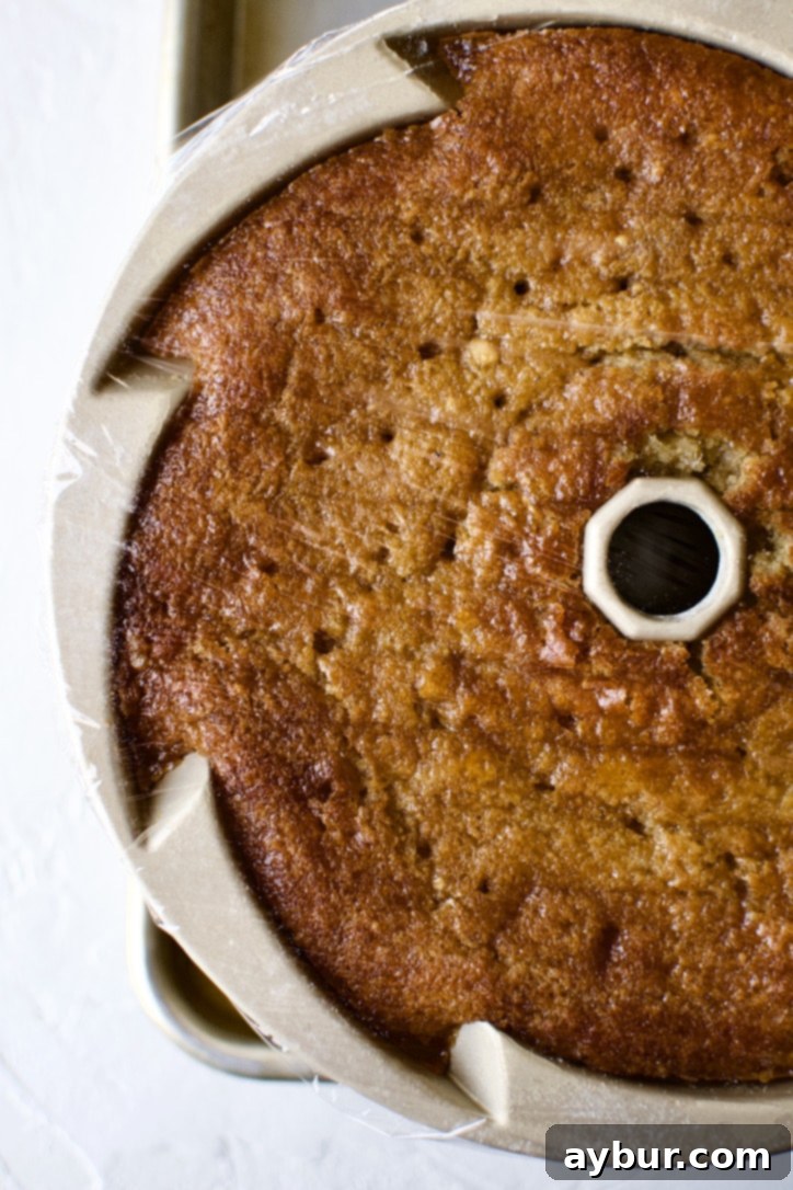 Cake cooling further in the pan after absorbing the initial whiskey soak.
