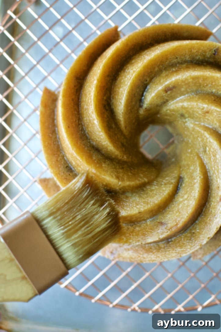 Brushing the top of the cooled cake with the remaining whiskey soak, adding an extra layer of flavor and moisture.