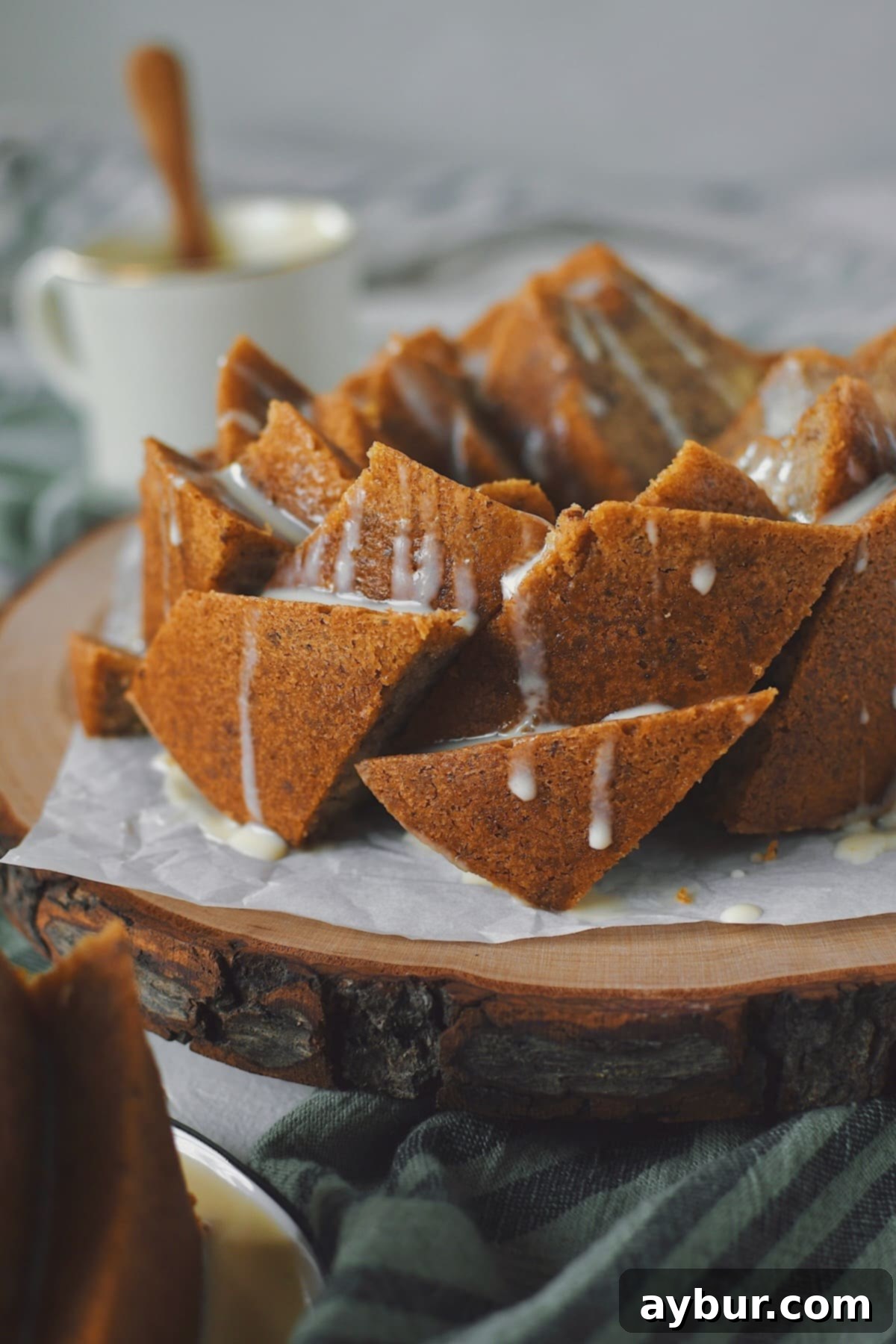 Another perspective of the sliced Brown Butter Cake, generously topped with Irish Whiskey Cream Sauce, showing the elegant presentation.
