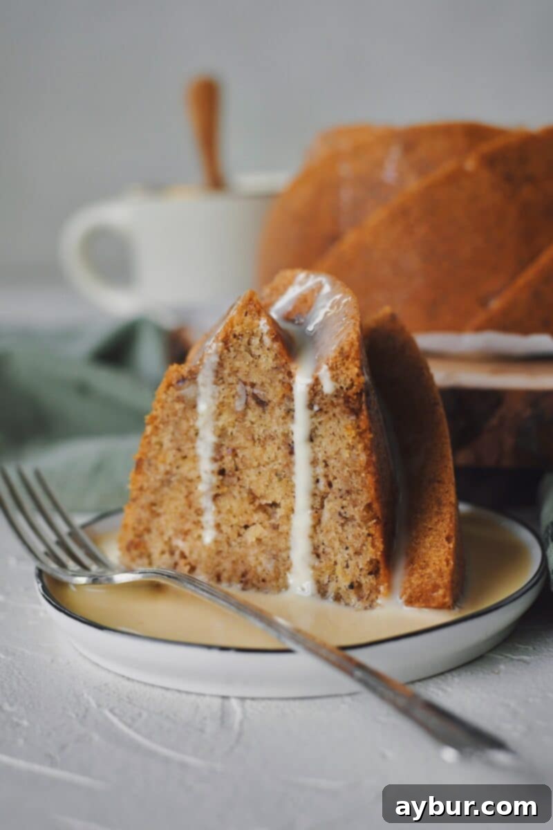 A close-up of a delicious slice of Brown Butter Cake with Irish Whiskey Cream Sauce, ready to be enjoyed.