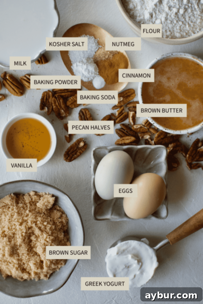 A collection of ingredients laid out, including butter, sugar, eggs, flour, spices, milk, yogurt, and Irish Whiskey, all ready for making Brown Butter Cake with Irish Whiskey Cream Sauce.