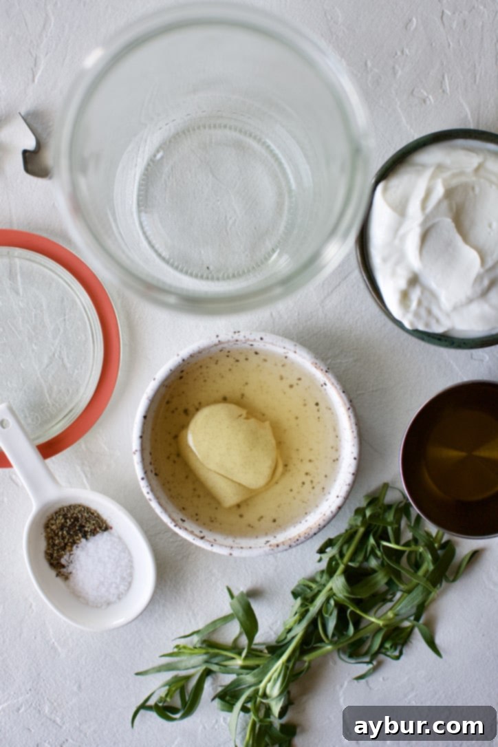 Ingredients for Tarragon Vinaigrette with a mixing jar.