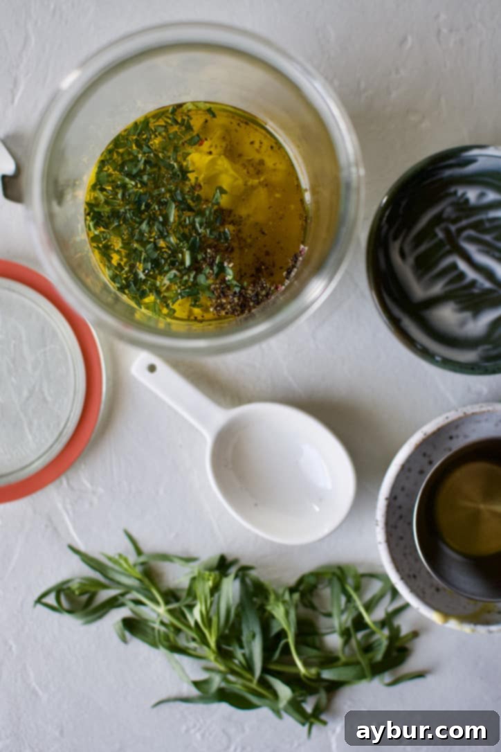 Tarragon Vinaigrette ingredients placed inside a jar ready for shaking.