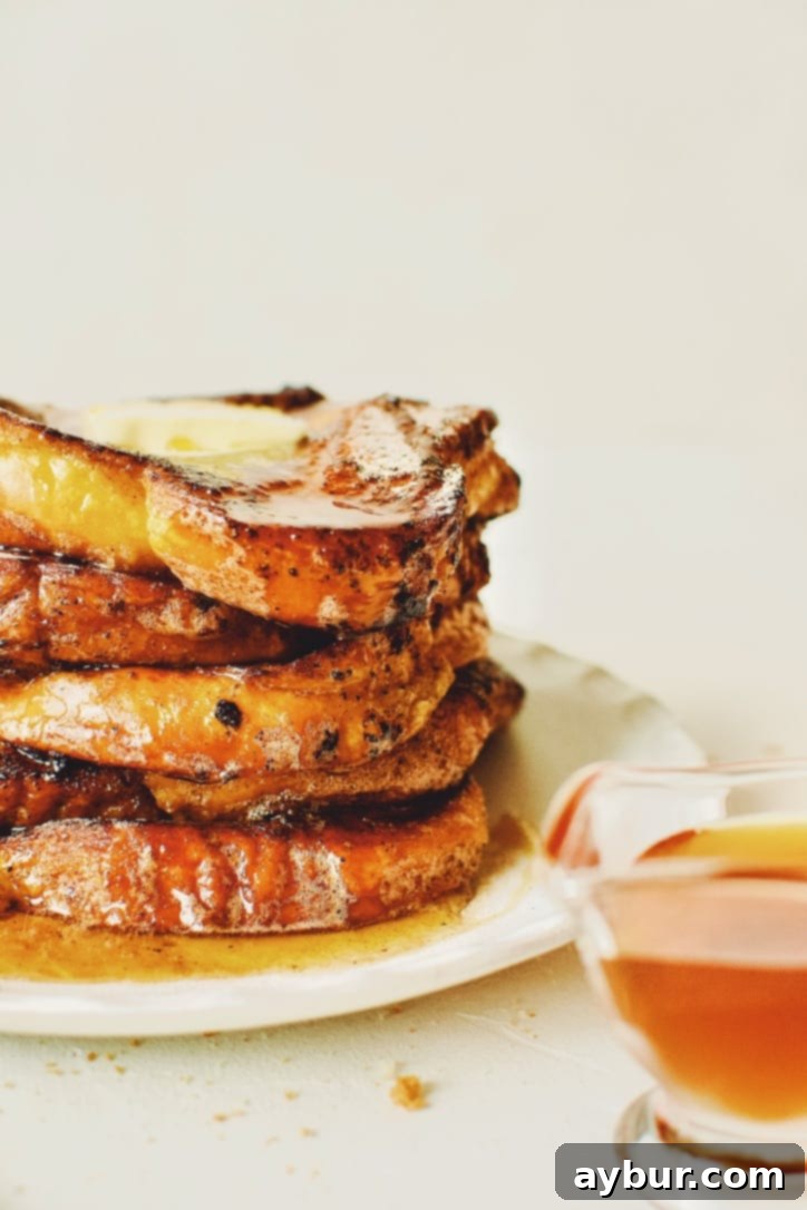 Close-up of finished Custard French Toast, featuring a rich, golden-brown crust, dusted with cinnamon sugar, and ready to be served.