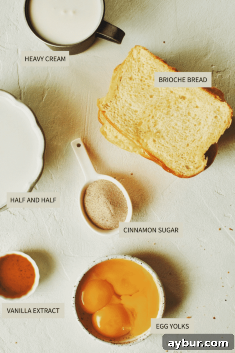 A selection of fresh ingredients laid out, including eggs, cream, vanilla, cinnamon, sugar, and a loaf of brioche bread, all ready for making French Toast.
