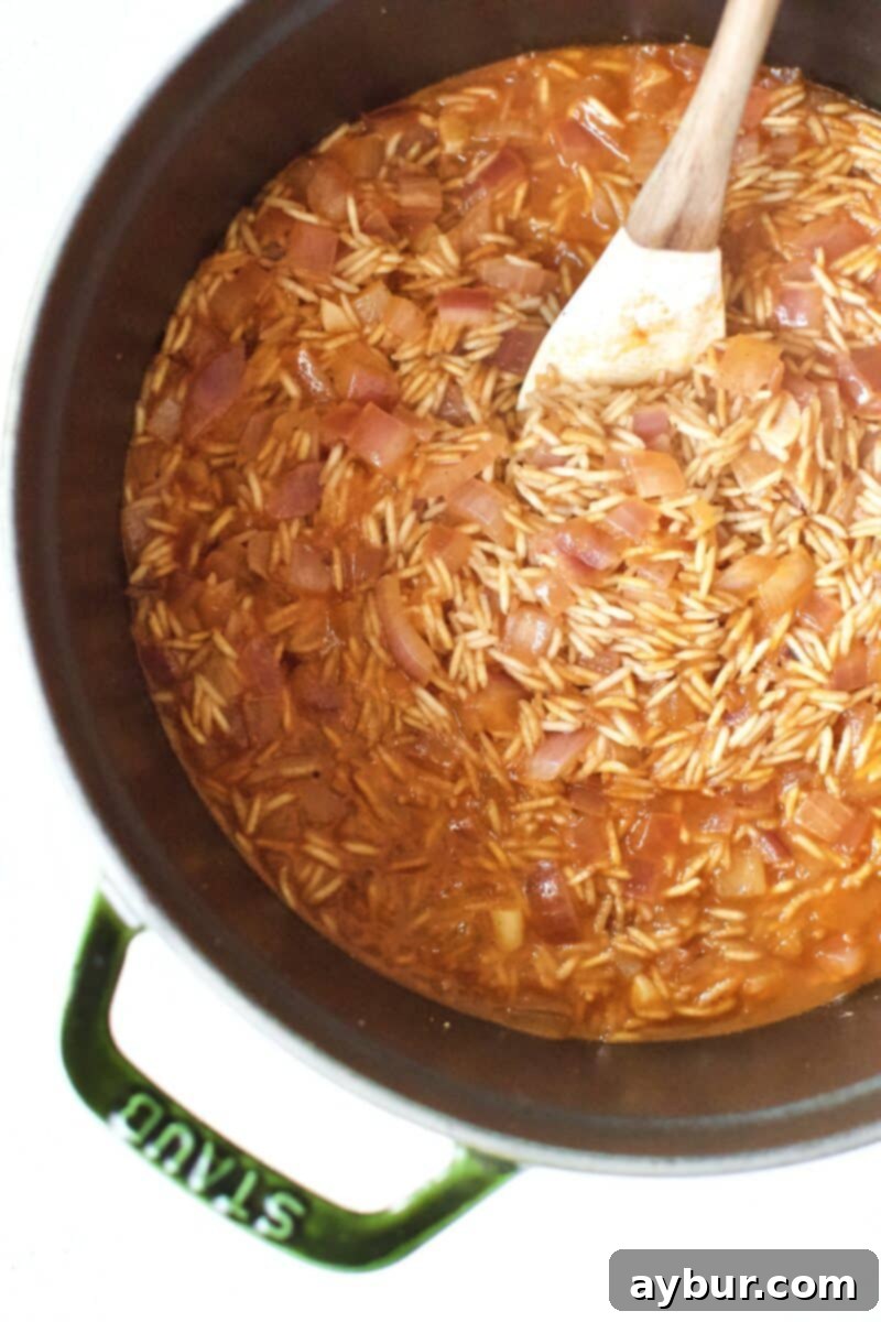 The rice after it's enitial cooking with the tomato sauce and chicken stock added.