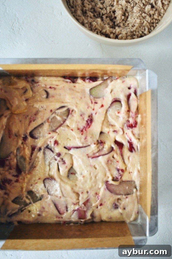 Raspberry Rhubarb Buckle batter in the prepared baking tin before topping.