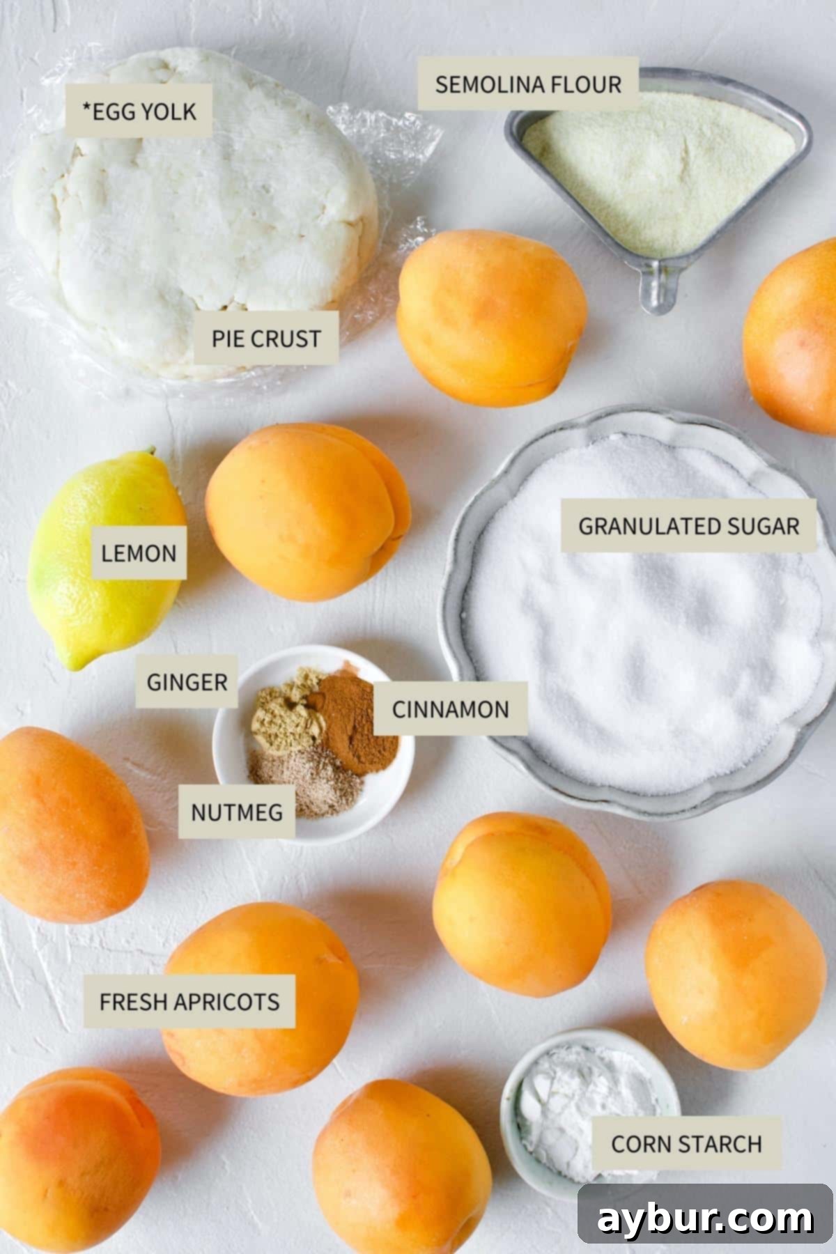 Golden Apricot Cobbler 3 A selection of fresh apricots, butter sticks, granulated sugar, flour, milk, and various spices arranged on a rustic wooden surface, ready for making Apricot Cobbler.