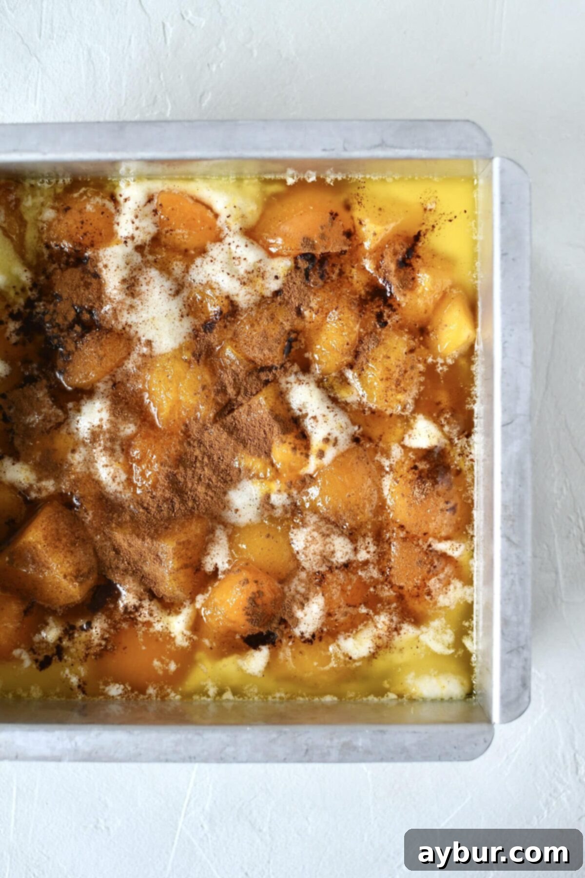 Golden Apricot Cobbler 9 The layered apricot cobbler in its baking tin, topped with spices, just before it goes into the oven.