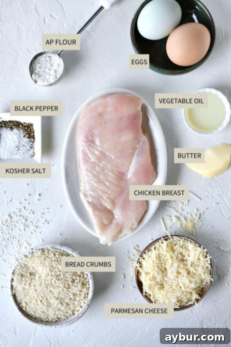 All the fresh ingredients meticulously arranged for making Crispy Parmesan Chicken.