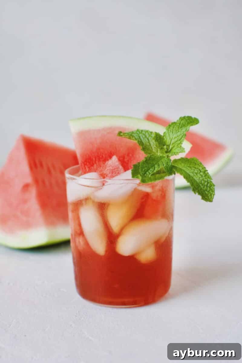 Vibrant pitcher of Watermelon Sweet Tea Sangria with fresh watermelon chunks.