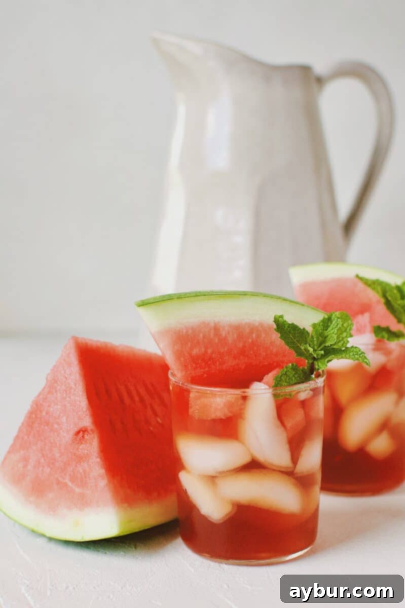 Pitcher of Watermelon Sweet Tea Sangria on an outdoor table.