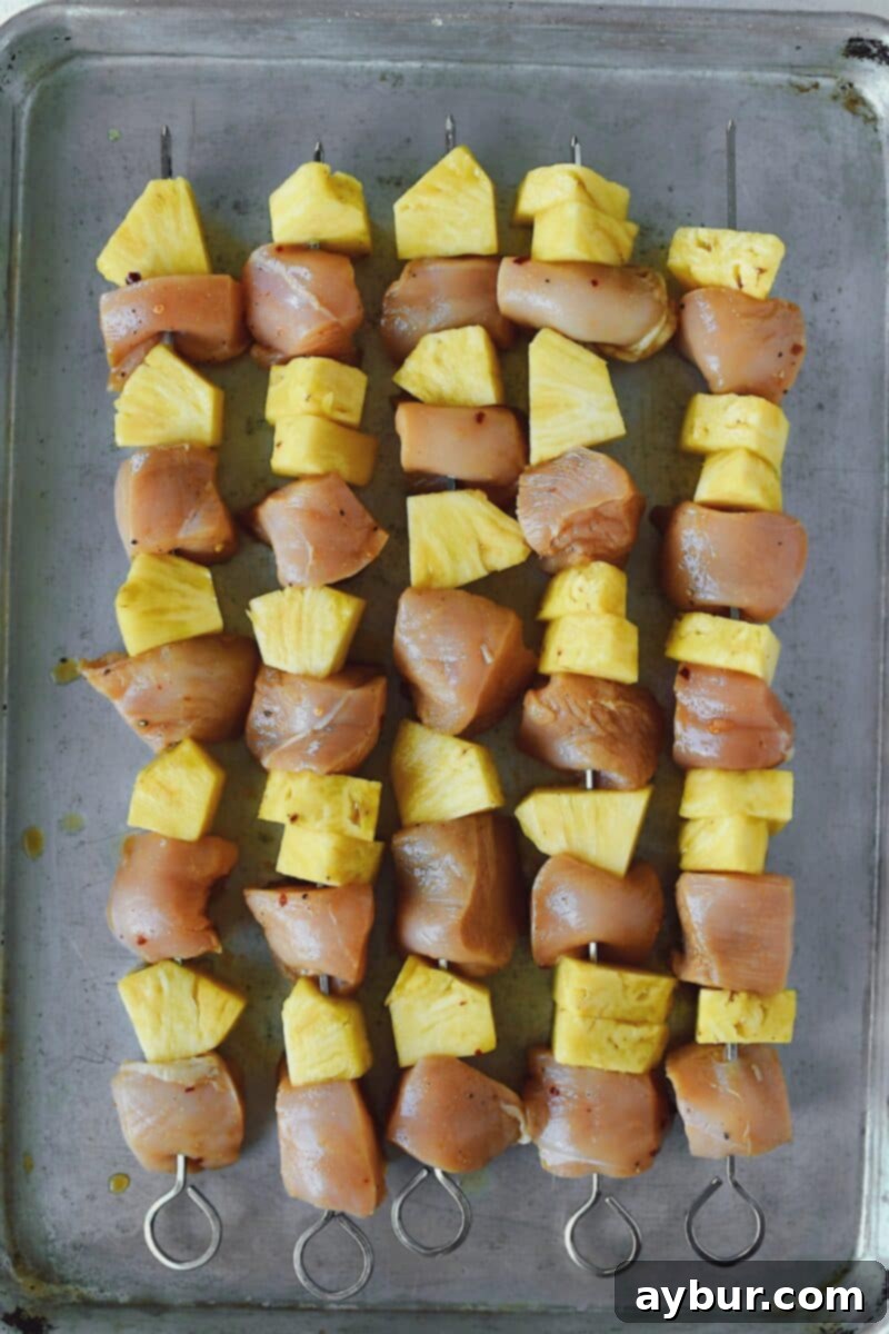 Tropical Peanut Chicken Skewers 6 Marinated chicken and pineapple skewered and ready to be grilled.