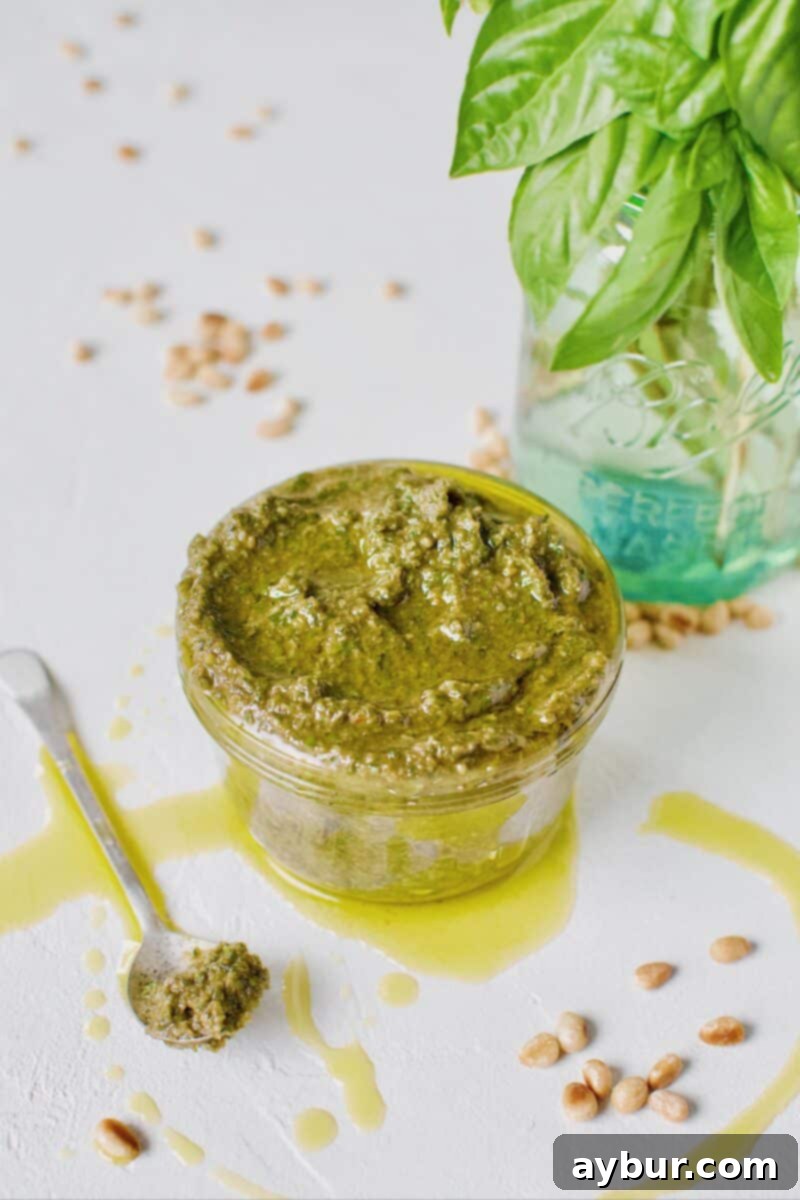 Fresh Basil Pesto Sauce just made and placed in a jar for storage, showcasing its vibrant green color.