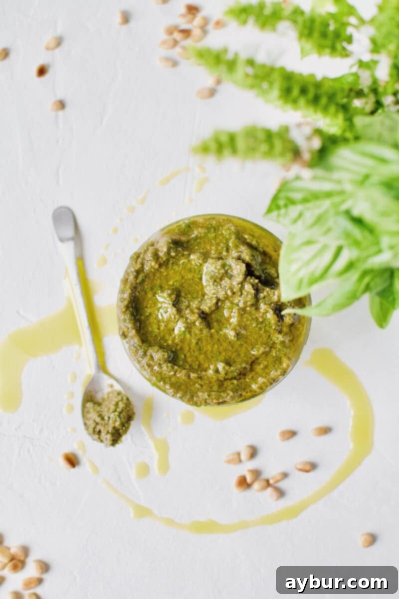 Fresh Basil Pesto Sauce, a finished batch, just made and placed in a jar for storage, vibrant green and textured.
