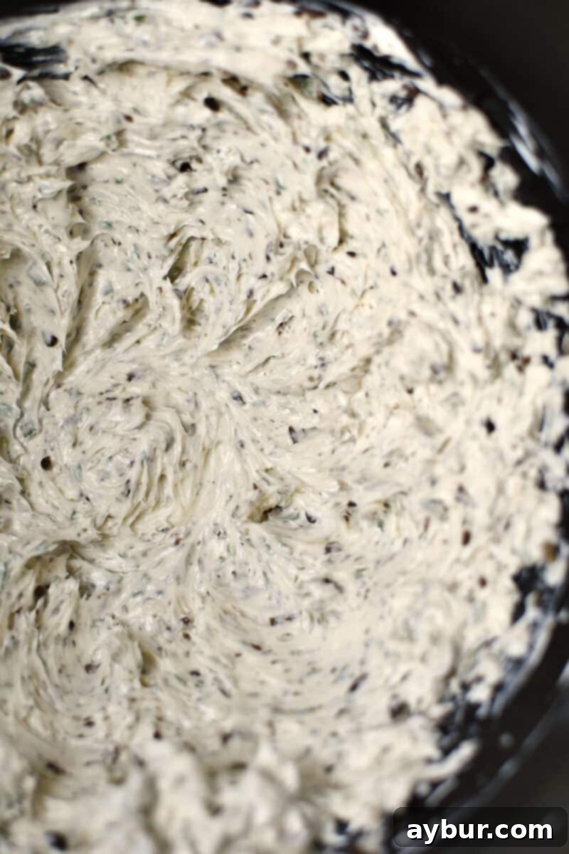 Gourmet Black Truffle Butter 7 The final stage of mixing: fluffy butter in a stand mixer, now beautifully combined with black truffles, garlic, and parsley, creating a truly luxurious compound butter ready for shaping.