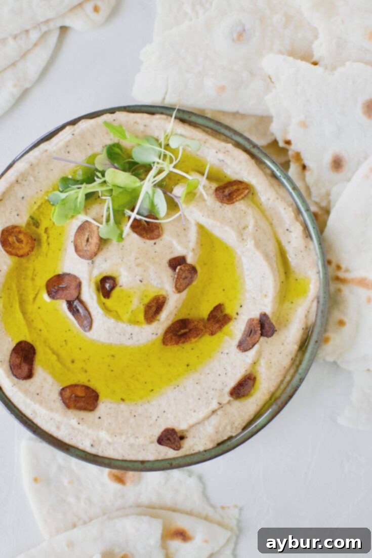 Smoky Baba Ghanoush with Golden Garlic 16 Baba Ghanoush with Toasted Garlic in a bowl, topped with olive oil and sliced toasted garlic.