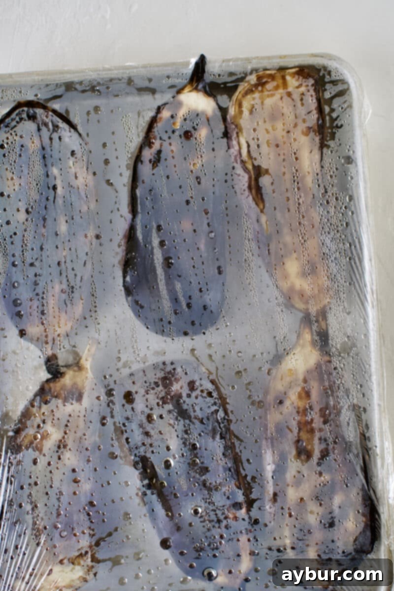 Smoky Baba Ghanoush with Golden Garlic 10 Grilled eggplant fresh off the grill, covered tightly with plastic wrap to steam.